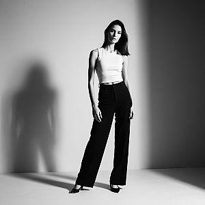Confident Woman in Minimalist Studio