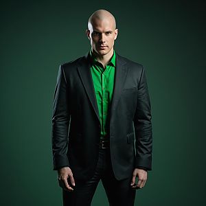 Confident Bald Man in Black Suit and Green Shirt Portrait