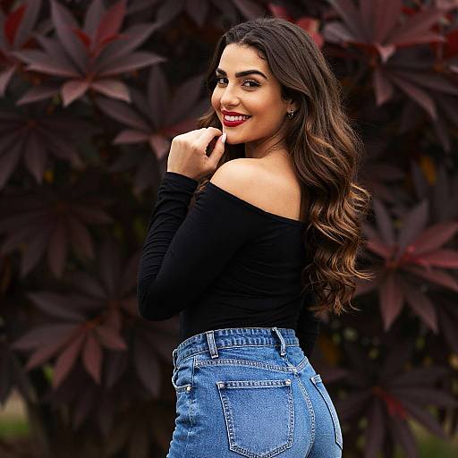 Woman in Off-Shoulder Black Top and Blue Jeans Smiling Outdoors
