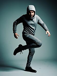 Photorealistic Studio Portrait of Man in One-Legged Costume in Gray Hoodie