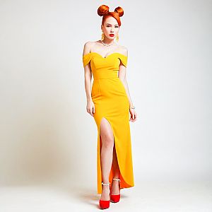 Confident Woman in Yellow Gown with Red Hair