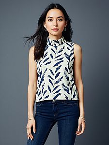 Woman Wearing Casual Sleeveless High Neck Top with Abstract Feather Print