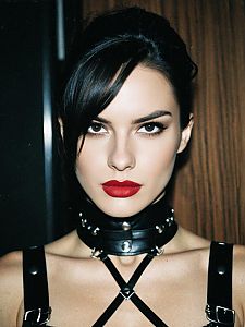Woman in Dominatrix Costume with Leather Choker and Straps Close-up