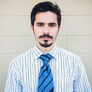 Confident Young Man in Striped Shirt and Tie