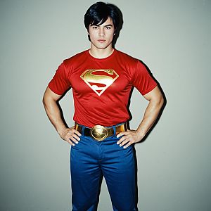 Young Man Wearing Red Superman Shirt and Blue Pants Posing in Studio