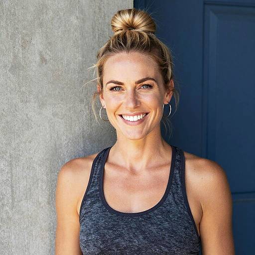 Smiling Woman in Athletic Wear with Blonde Hair Bun