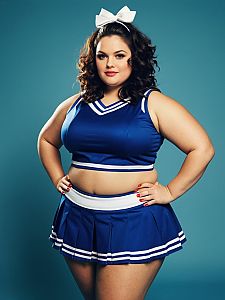 Plus Size Woman in Blue Cheerleader Costume Waist Up Editorial Photo