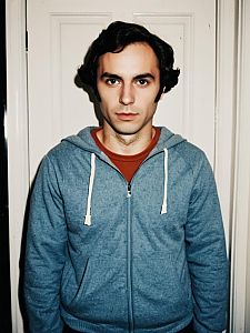 Man Wearing Ted Bundy Costume in Blue Hoodie and Rust Shirt