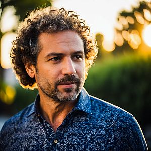 Thoughtful man outdoors at golden hour