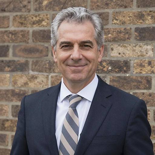 Confident Middle-Aged Man in Navy Suit with Striped Tie Against Brick Wall