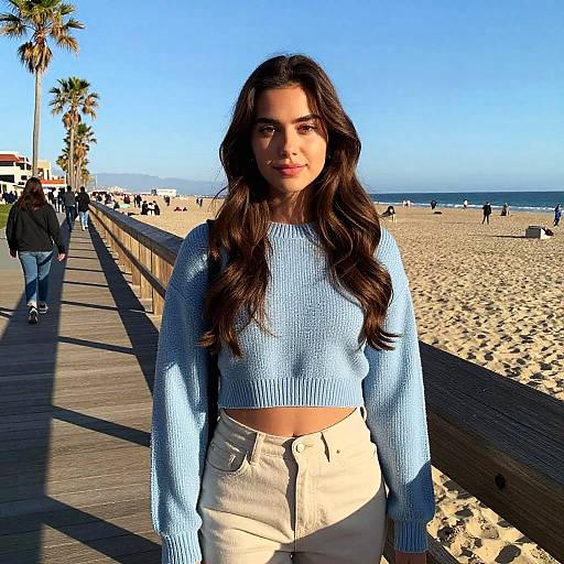 Gen Z Woman in Blue Cropped Sweater on Sunny Beach Boardwalk