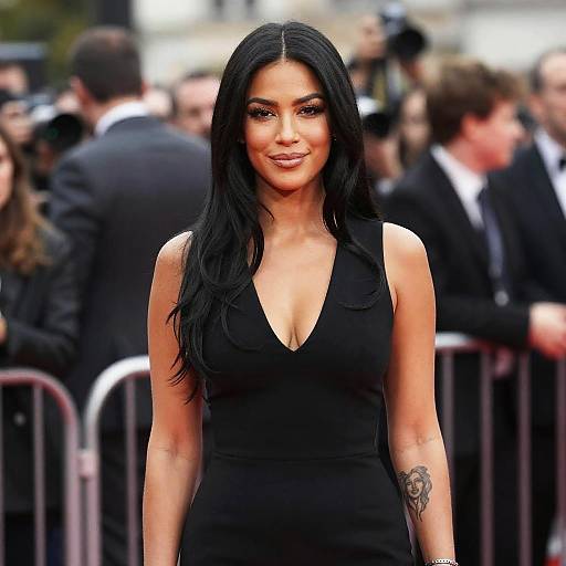 Elegant Woman in Black Dress with Forearm Tattoo at Formal Event