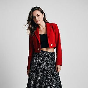 Stylish Woman in Red Blazer and Polka Dot Skirt
