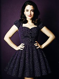 Vintage Style Woman in Purple Polka Dot Dress Posing Confidently