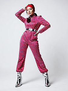 Woman in Retro-Futuristic Pink Polka Dot Jumpsuit with Metallic Silver Accents