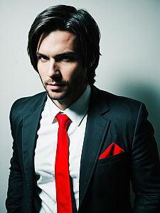 Alex Mercer Cosplay Man in Black Suit with Red Tie Realistic Photo