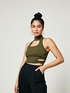Woman in Olive Green Cut-Out Ribbed Tank Top and Black High-Waisted Pants Street Style