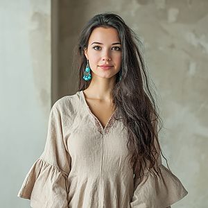 Young Woman in Beige Blouse with Turquoise Earrings