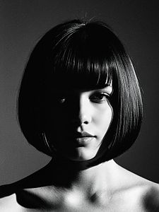Black and White Portrait of Woman with Bob Haircut in Dramatic Lighting