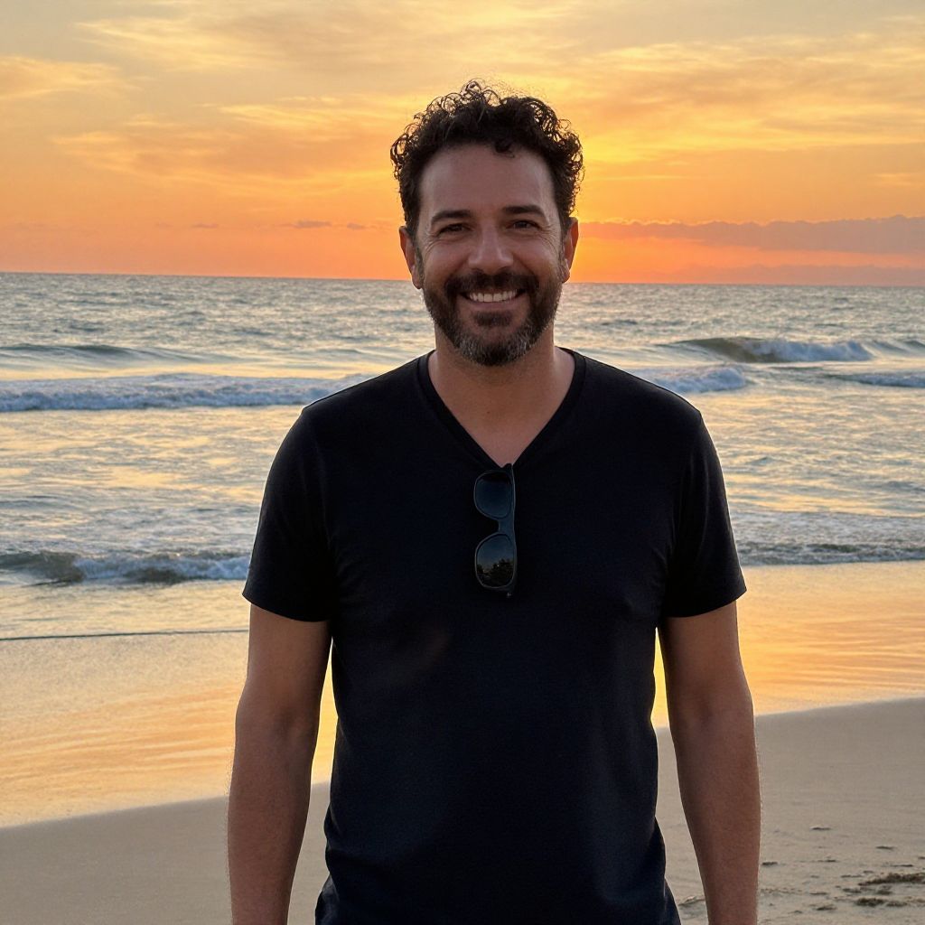 Man Smiling on Beach at Sunset with Ocean Waves