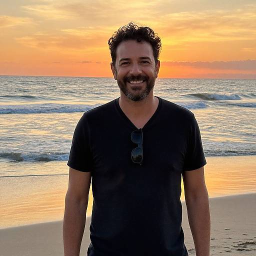Man Smiling on Beach at Sunset with Ocean Waves