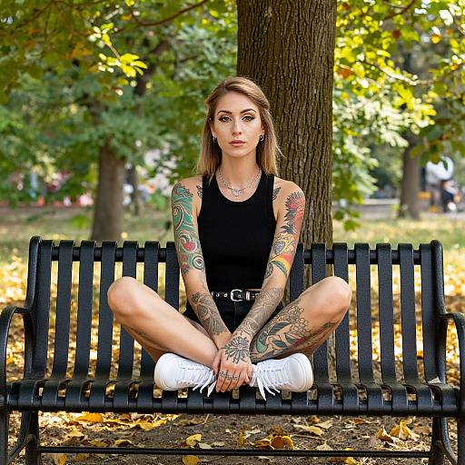 Tattooed Woman Sitting on Park Bench in Autumn