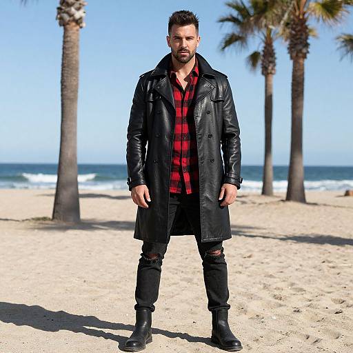 Stylish Man in Leather Trench Coat and Red Checkered Shirt on Beach
