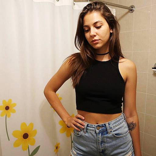 Young Woman in Black Crop Top and Denim Shorts Posing Indoors
