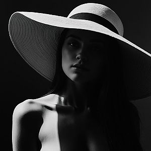 Dramatic Black and White Portrait of a Woman in a Hat