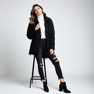 Chic Woman in Black Coat and White Turtleneck