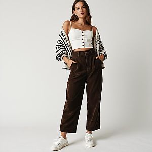 Casual Chic Woman Wearing Cropped White Bustier Top and High Waist Brown Corduroy Pants