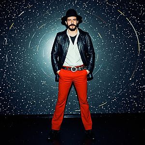 Man in Retro Disco Outfit Against Cosmic Background