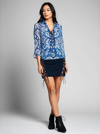 Woman in Blue Paisley Semi-Sheer Blouse and Black Lace-Up Mini Skirt
