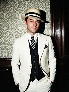 Man in Classic Gatsby Party Costume with White Suit and Fedora Hat