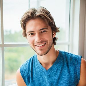 Smiling Young Man by Bright Window