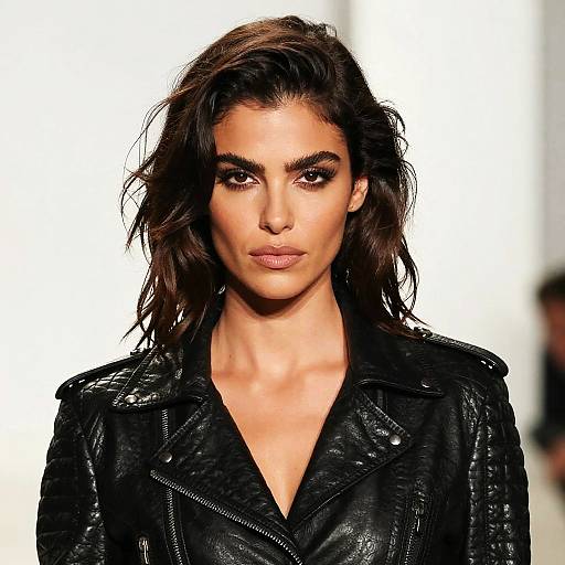 Fierce Woman in Black Leather Jacket on Runway Fashion Show