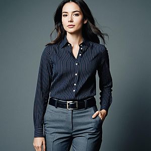 Confident Woman Wearing Navy Pinstriped Shirt and Grey Pants Studio Portrait