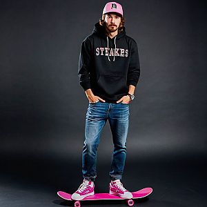 Young Man on Pink Skateboard in Streetwear