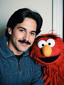 Man with Mustache Posing with Elmo Costume Puppet