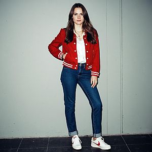Confident Woman in Red Varsity Jacket