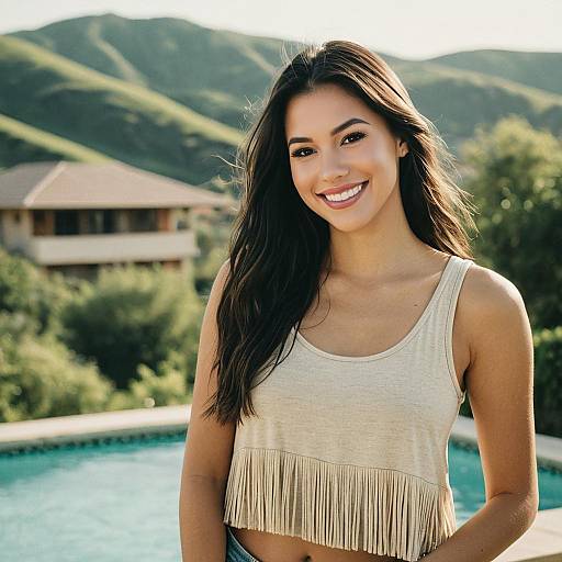 Smiling Young Woman Outdoors by Pool with Hills Background