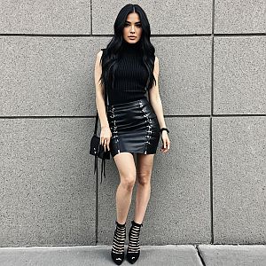 Stylish Urban Woman in Black Leather Mini Skirt and Sleeveless Turtleneck