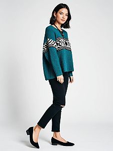 Woman in Casual-Chic Oversized Teal Knit Sweater with Ribbed Texture