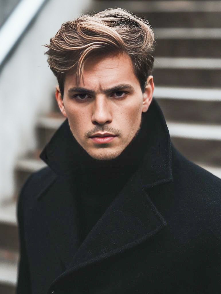 Stylish Man on Staircase in Chic Black Attire