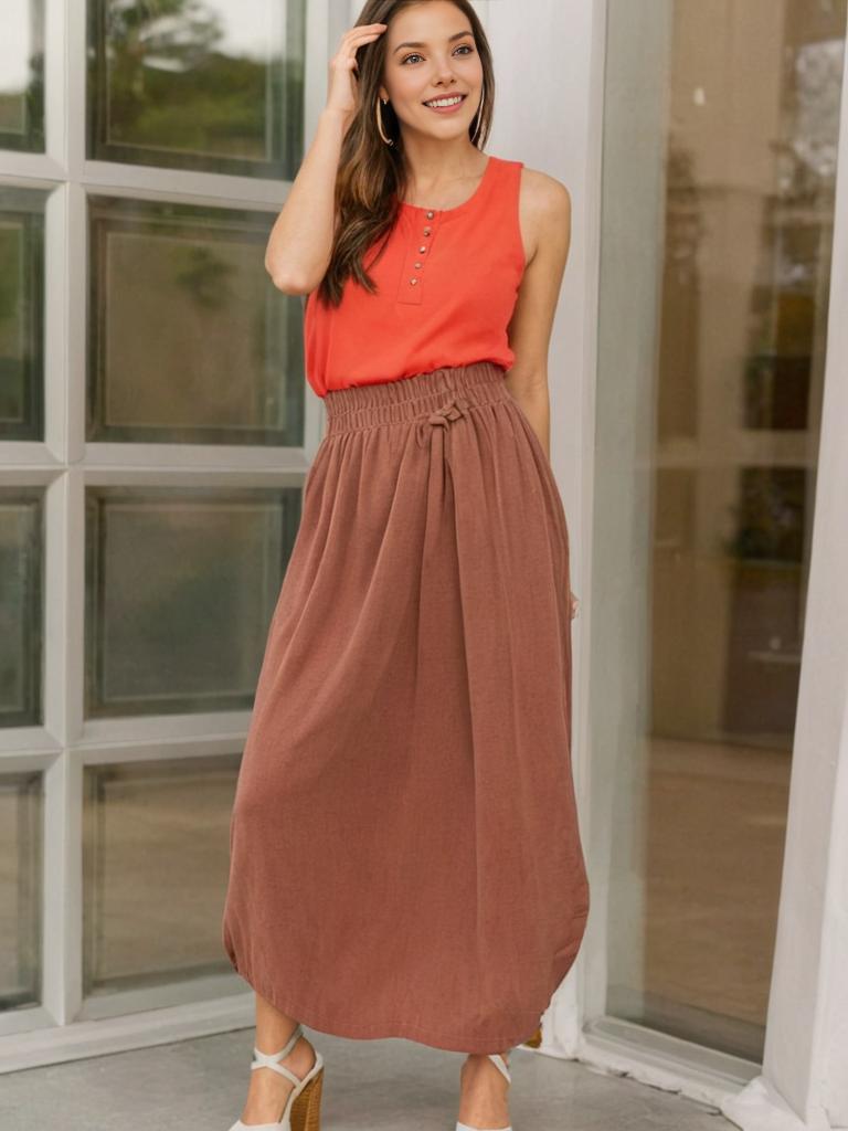 Stylish woman in coral top and brown skirt by glass door