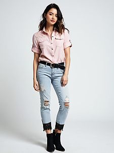 Woman in Casual Pink Shirt and Ripped Jeans with Lace Detail