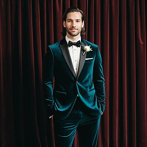 Stylish Man in Teal Velvet Tuxedo with Bow Tie and Boutonniere