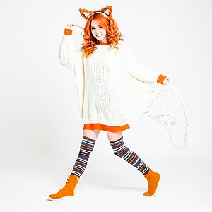 Cheerful woman in oversized sweater and fox ears