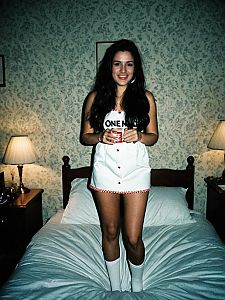 Young Woman in One Night Stand Fancy Dress in Vintage Bedroom