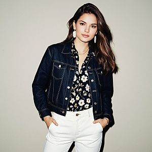 Confident Woman in Denim Jacket and Floral Blouse